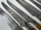 five knives that are sitting on top of each other
