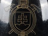a black vase with a gold design on it