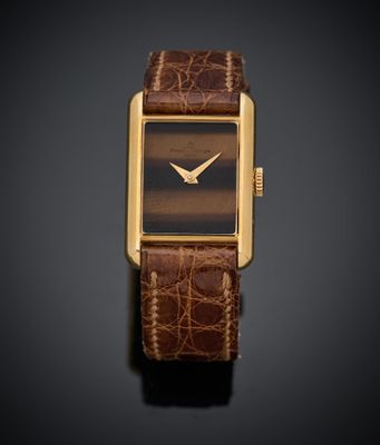 une image représentant une montre avec un bracelet en cuir marron sur fond noir
