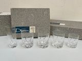 four glasses and a box on the table