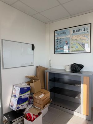 a room with a desk and a lot of boxes