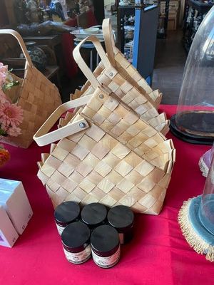 a table with a basket, a bag, and other items on it
