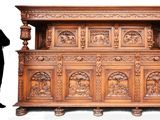a man standing in front of a large wooden cabinet