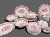 many plates and cups that are sitting on a table