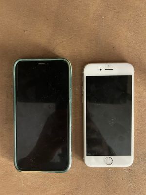 two iphones sitting next to each other on a table