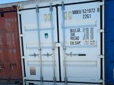 two shipping containers sitting next to each other on the ground