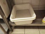 a toilet and a trash can in a public restroom