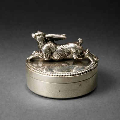 a silver box with a rabbit on top of it