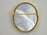 gold plated brooch with mother of pearl in a circle