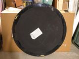 a large black object sitting on a cardboard box