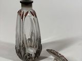 a small glass vase with a black top and a silver base