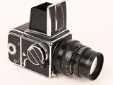 a black and silver camera on a white background