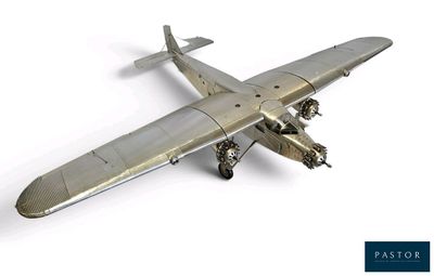 a silver model of a plane on a white surface