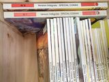 a lot of books that are stacked on top of each other