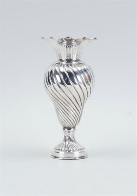 an image of a silver vase sitting on top of a table