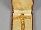 an image of a gold cross in a case on a table