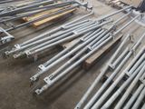 a lot of metal pipes and poles in a warehouse