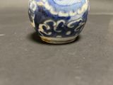 a small blue and white vase sitting on a table