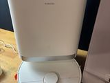 an image of a white air purifier sitting on top of a wooden table