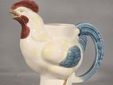 a white and blue mug with a rooster on it