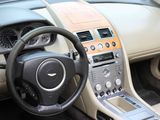 the interior of a car with a steering wheel and dashboard controls