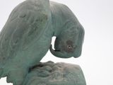 a statue of a bird that is sitting on top of a rock