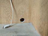 a white cord that is plugged into a wooden wall