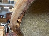 a large vase that is sitting on a wooden table