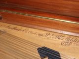 a close up of an old piano with a black cat on it
