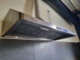 an image of a stainless steel exhaust hood mounted on a wall