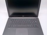 a dell laptop computer sitting on a white surface