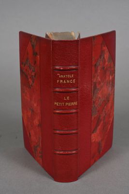a red book that is open on a table