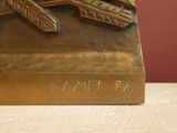 a bronze sculpture of a plane on display on a table