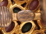 a close up of a gold object with a bee on it