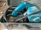 a blue electric drill in a metal case