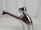 the faucet is shiny and chromed on a white surface