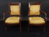 a pair of antique chairs with yellow upholstered upholstered cushions