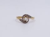 a close up of a gold ring with a pearl and diamonds