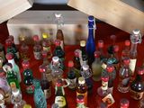 many bottles of alcohol sitting on a red table
