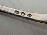 a close up of a silver spoon on a table