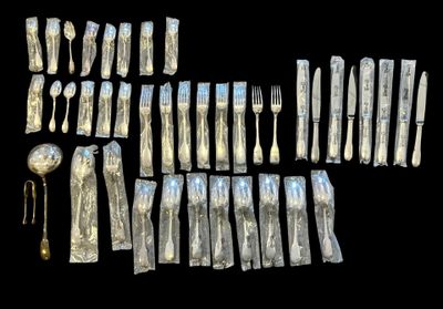a lot of silverware on a black background