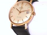a close up of a wrist watch on a white surface
