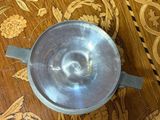 a silver cup sitting on top of a wooden table