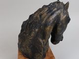 sculpture of a horse head on a wooden base
