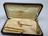 a box with a knife and a pen inside of it
