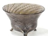 a glass bowl sitting on a stand on a white surface