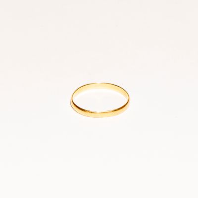 a gold wedding ring on a white background