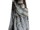 the woman is wearing a fur coat and black leggings