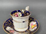 a close up of a cup and saucer on a table