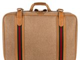 the suitcase is tan with a green and red stripe on the side